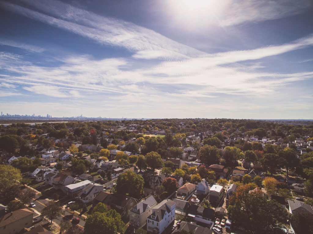 A wide shot of a suburban area with a city in the background