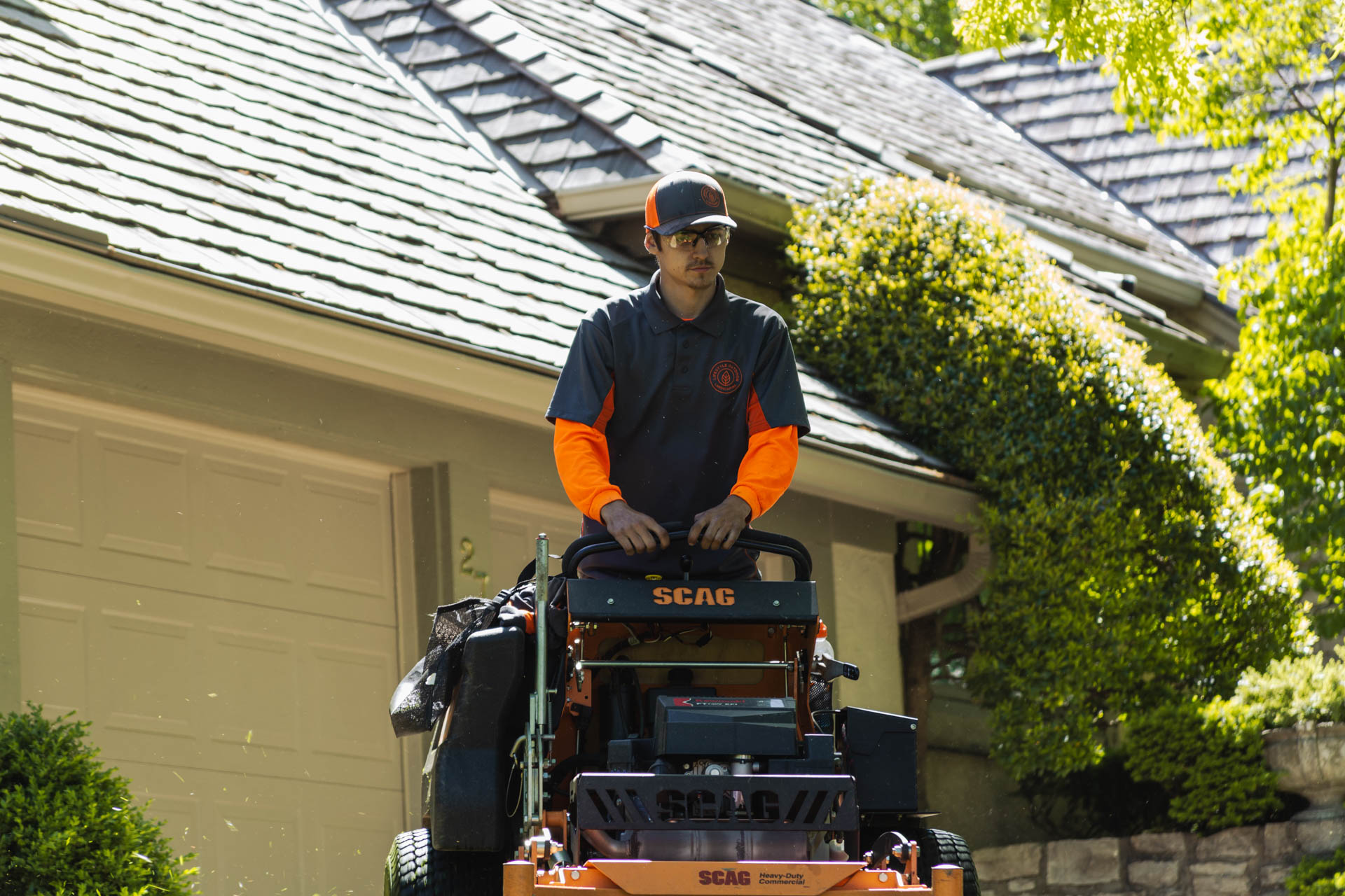 A man works as a part of our HOA Lawn Mowing Service in Overland Park